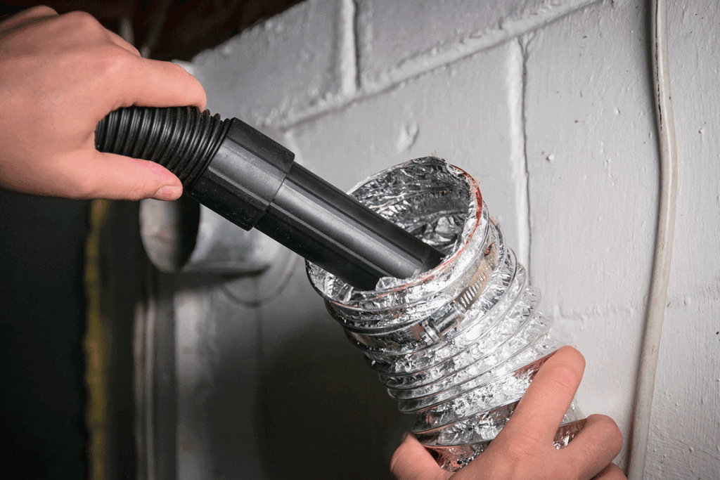 shows the reader what the dryer vent opening looks like and what the process of vacuuming should look like
